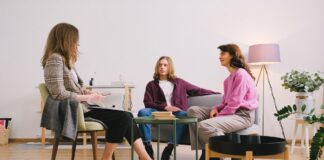 Three adults engaged in conversation in a modern living room