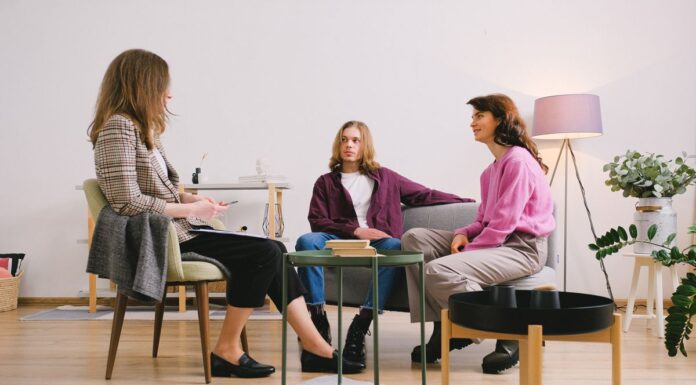 Three adults engaged in conversation in a modern living room