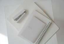 When Your Couples Therapist Is on Vacation: Plan Support During the Break Notebook, diary, and white stapler arranged on an open planner