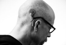 Couples Therapy When You Are Hard of Hearing: Asking for Communication Access Black and white profile of a man wearing glasses and a hearing aid