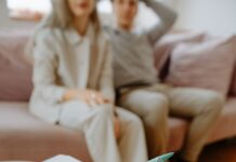 Therapist holding a notebook during a conversation with a couple