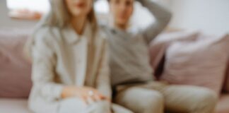 Therapist holding a notebook during a conversation with a couple