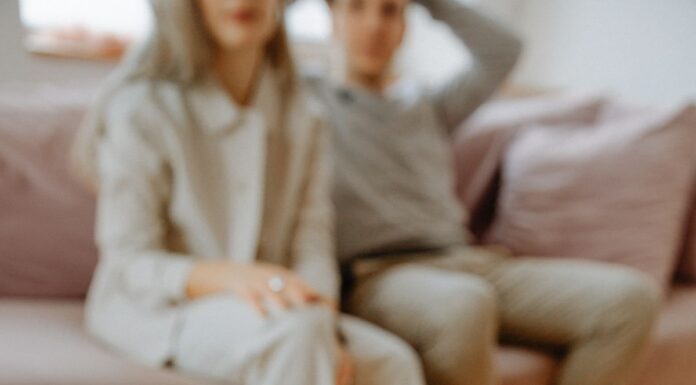 Couples Therapy Homework: What to Do When Between-Session Exercises Feel Too Hard Therapist holding a notebook during a conversation with a couple