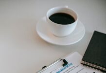 Couples Therapy Intake Forms: How to Prepare Without Writing a Perfect Story Clipboard with a questionnaire, pen, and coffee on a therapist office table