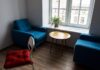 Modern living room with blue armchairs and wooden furniture