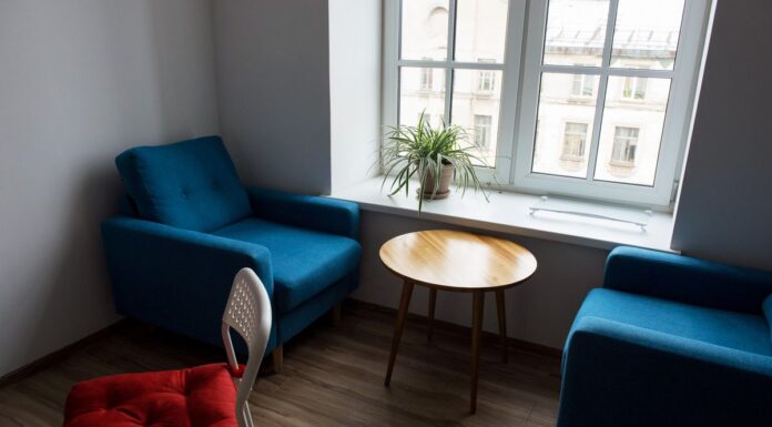 Modern living room with blue armchairs and wooden furniture