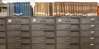 Metal filing cabinets holding rows of indexed documents