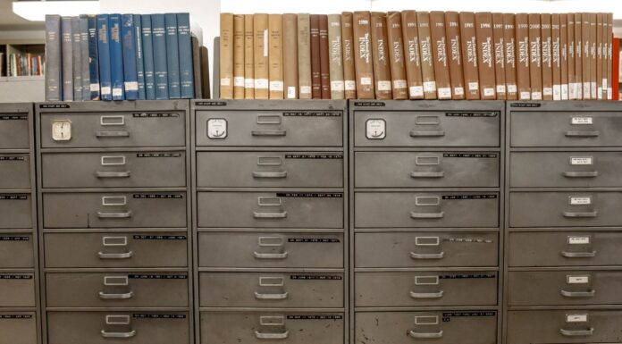Metal filing cabinets holding rows of indexed documents
