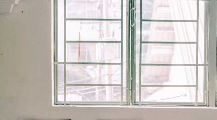 Two empty chairs beside a window in a waiting room