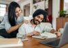 Couple at home reviewing paperwork with a laptop and calculator