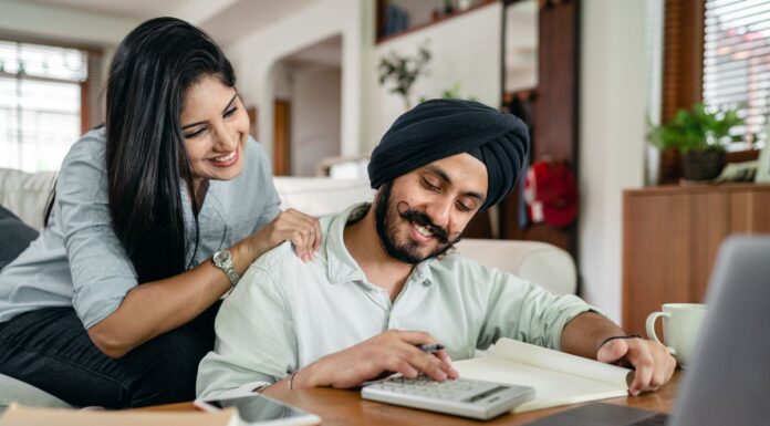 Couples Therapy Superbills: What to Check Before Seeking Reimbursement Couple at home reviewing paperwork with a laptop and calculator