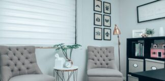 Gray chairs beside a white round table in a counseling office