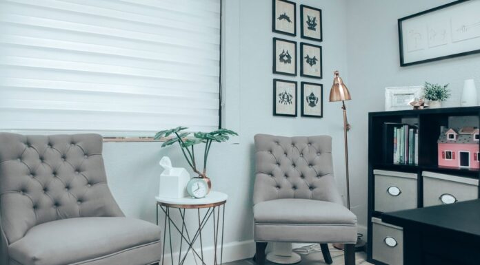 Gray chairs beside a white round table in a counseling office
