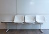 White chairs in an empty indoor waiting area