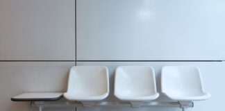 White chairs in an empty indoor waiting area