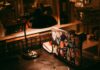Laptop, lamp, and books on a warmly lit desk
