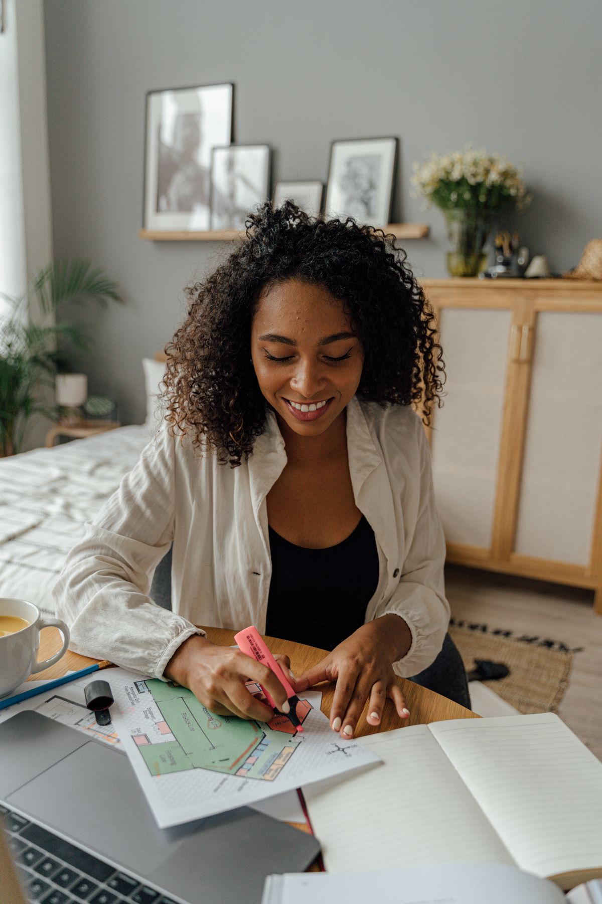 Woman working with a laptop and papers at home