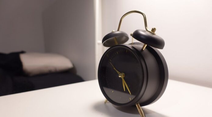 Couples Therapy When You Work Night Shifts: Scheduling Without Losing Sleep Black vintage-style alarm clock on a bedside table