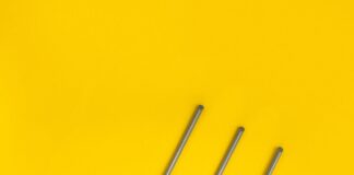 White Wi-Fi router with antennas and cables on a yellow background