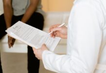 Healthcare professional reviewing a form during a consultation
