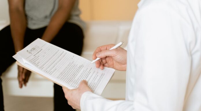 Healthcare professional reviewing a form during a consultation