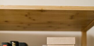 Cardboard boxes on a wooden bookshelf among books